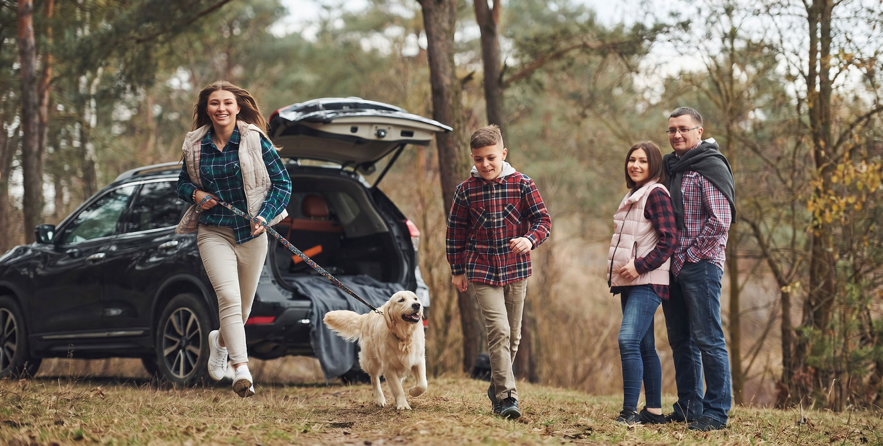 Family with car and dog